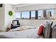 Tranquil bedroom featuring natural light, city views, and a cozy reading chair at 100 Park Ave # 907, Denver, CO 80205