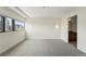 Bright bedroom with gray carpet, modern sconces, and a cityscape view from the large window at 100 Park Ave # 907, Denver, CO 80205