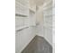Walk-in closet with built-in shelving and carpeting at 100 Park Ave # 907, Denver, CO 80205