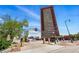 Exterior view of building with archway sign and parking lot, showcasing its architecture at 100 Park Ave # 907, Denver, CO 80205