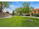 Lush green community space featuring manicured lawn with seating and landscaped areas for outdoor enjoyment at 100 Park Ave # 907, Denver, CO 80205