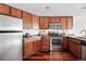 Functional kitchen design featuring wooden cabinets and modern appliances in a compact space at 100 Park Ave # 907, Denver, CO 80205