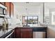 Bright kitchen view to the living room, with stainless steel appliances and sleek countertops at 100 Park Ave # 907, Denver, CO 80205