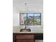 Granite counter features faucet, with balcony with a city view behind at 100 Park Ave # 907, Denver, CO 80205
