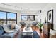 Cozy living room with a city view, stylish furniture, and elegant hardwood flooring at 100 Park Ave # 907, Denver, CO 80205