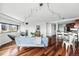 Bright living room featuring hardwood floors, modern lighting, and comfortable seating arrangement at 100 Park Ave # 907, Denver, CO 80205