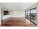 Open living area features hardwood floors, track lighting, and a balcony at 100 Park Ave # 907, Denver, CO 80205