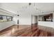 Bright living room boasts hardwood floors, sleek track lighting, and city views at 100 Park Ave # 907, Denver, CO 80205