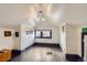 Attic space with hardwood floors, painted trim and walls, and natural light from the window at 1229 Josephine St, Denver, CO 80206