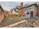 Backyard featuring a patio with metal table and chairs, wooden fence, and exterior view at 1229 Josephine St, Denver, CO 80206