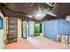 Unfinished basement with two doorways, painted brick walls, and black fabric ceiling cover at 1229 Josephine St, Denver, CO 80206