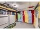 Laundry room with washer and dryer, colorful walls, and pipes on the ceiling at 1229 Josephine St, Denver, CO 80206