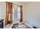 Bedroom featuring a patterned rug, and windows with patterned curtains and natural light at 1229 Josephine St, Denver, CO 80206