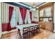 Elegant dining room with an antique china cabinet and vintage-inspired wallpaper and curtains at 1229 Josephine St, Denver, CO 80206
