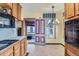 Retro kitchen boasts wood cabinets, a gas stovetop, and a unique red and grey painted door at 1229 Josephine St, Denver, CO 80206