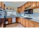 Cozy kitchen with ample counter space, modern appliances, and warm-toned cabinetry at 1229 Josephine St, Denver, CO 80206
