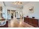 Open-concept living room with hardwood floors and decorative shelving leading to the dining area at 1229 Josephine St, Denver, CO 80206
