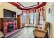 Cozy living room with hardwood floors, fireplace, and large windows dressed with floral curtains at 1229 Josephine St, Denver, CO 80206