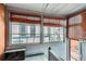 Sunroom with wood blinds, beadboard walls and ceiling, and staircase at 1229 Josephine St, Denver, CO 80206