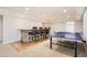 Finished basement features a stone bar and a ping pong table at 10726 Amesbury Way, Highlands Ranch, CO 80126