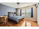 Bright bedroom with hardwood floors and a big window with a view of the outside at 10726 Amesbury Way, Highlands Ranch, CO 80126