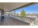 Enjoy the view from this spacious wooden deck with white railings at 10726 Amesbury Way, Highlands Ranch, CO 80126