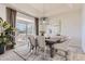 Elegant dining room featuring a modern chandelier and sliding glass doors to the outdoor deck at 10726 Amesbury Way, Highlands Ranch, CO 80126