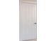 A bright white interior door with four panels and a chrome lever handle at 10726 Amesbury Way, Highlands Ranch, CO 80126
