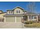 Inviting two-story home with a two-car garage, covered porch, and lovely landscaping enhancing its curb appeal at 10726 Amesbury Way, Highlands Ranch, CO 80126