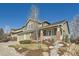 Beautiful home features a spacious two-car garage, a covered front porch, and manicured landscaping at 10726 Amesbury Way, Highlands Ranch, CO 80126