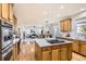 Spacious kitchen with island, stainless appliances, and hardwood floors open to the living area at 10726 Amesbury Way, Highlands Ranch, CO 80126