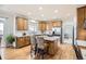 Inviting kitchen showcases hardwood floors, an island with seating, and stainless appliances at 10726 Amesbury Way, Highlands Ranch, CO 80126