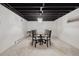 Finished basement with exposed beams, a dining area and white painted walls at 3756 S Chase St, Denver, CO 80235