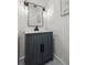 Contemporary half bathroom with a blue vanity, and modern fixtures at 3756 S Chase St, Denver, CO 80235