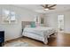 Bright bedroom with a ceiling fan, windows and an ensuite bathroom at 3756 S Chase St, Denver, CO 80235