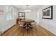 Elegant dining room featuring hardwood floors, stylish chandelier, and ample natural light at 3756 S Chase St, Denver, CO 80235