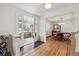Welcoming foyer opening into a dining room with hardwood floors and stylish decor at 3756 S Chase St, Denver, CO 80235