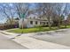 Exterior view of a well-maintained home with a manicured lawn and mature trees at 3756 S Chase St, Denver, CO 80235
