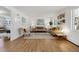 Bright living room featuring hardwood floors, neutral paint, stylish furniture, and plenty of natural light at 3756 S Chase St, Denver, CO 80235