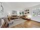 Inviting living room featuring hardwood floors, neutral colors, stylish furnishings, and decorative wall art at 3756 S Chase St, Denver, CO 80235
