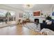 Bright living room featuring a fireplace, backyard access, and lots of natural light at 3756 S Chase St, Denver, CO 80235