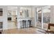 Open-concept living space featuring a kitchen view, bar seating, and access to the outdoor deck at 3756 S Chase St, Denver, CO 80235