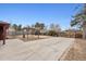 Large backyard featuring a covered patio, wooden pergola, and gated fence at 2835 N Monaco Pkwy, Denver, CO 80207