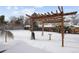 Spacious backyard featuring a pergola and well-maintained landscaping at 2835 N Monaco Pkwy, Denver, CO 80207