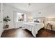 Bright bedroom featuring hardwood floors, large window, and neutral decor at 2835 N Monaco Pkwy, Denver, CO 80207