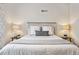 Cozy bedroom featuring neutral bedding, wood headboard, and bedside tables with lamps at 2835 N Monaco Pkwy, Denver, CO 80207