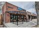 Attractive brick storefront featuring outdoor dining area and decorative lighting, ideal for a relaxed dining experience at 2835 N Monaco Pkwy, Denver, CO 80207