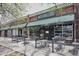 Charming restaurant exterior with inviting outdoor seating, complemented by string lights and a dark awning at 2835 N Monaco Pkwy, Denver, CO 80207