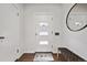 Bright foyer features a stylish rug, a modern bench, and a sleek mirror at 2835 N Monaco Pkwy, Denver, CO 80207