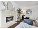 A living room featuring a tile fireplace, modern furniture, and warm natural light at 2835 N Monaco Pkwy, Denver, CO 80207